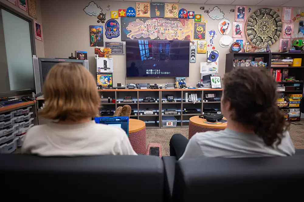 Two students playing a game in Japanese on the MARLA TV.